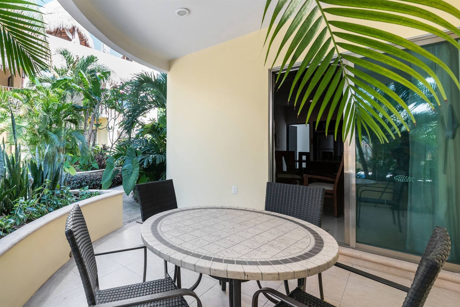 Villas Akalan: private balcony with a table for four, facing the garden